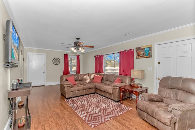 living room featuring hardwood / wood-style floors, ornamental molding, and ceiling fan