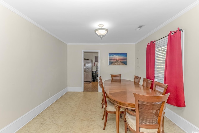 dining space featuring ornamental molding