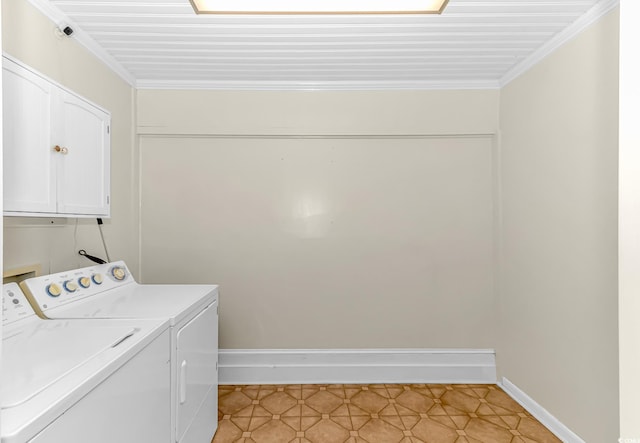 washroom featuring ornamental molding, cabinets, and washing machine and clothes dryer