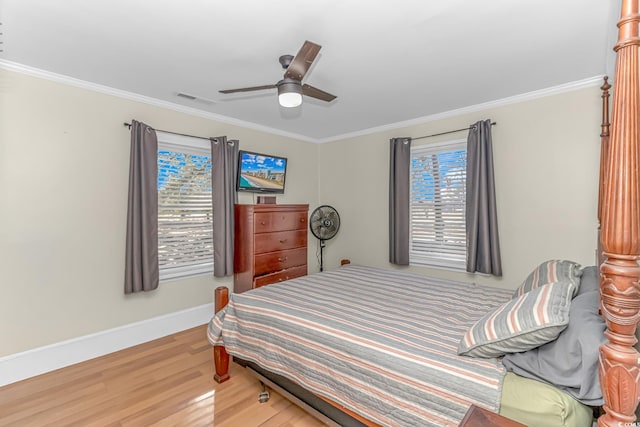 bedroom with ceiling fan, ornamental molding, and wood-type flooring