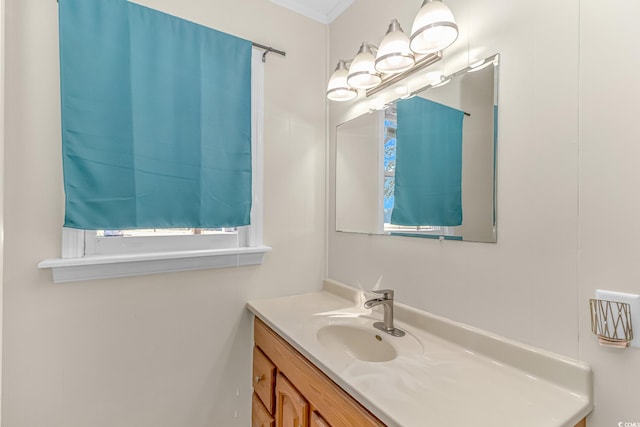 bathroom featuring crown molding and vanity