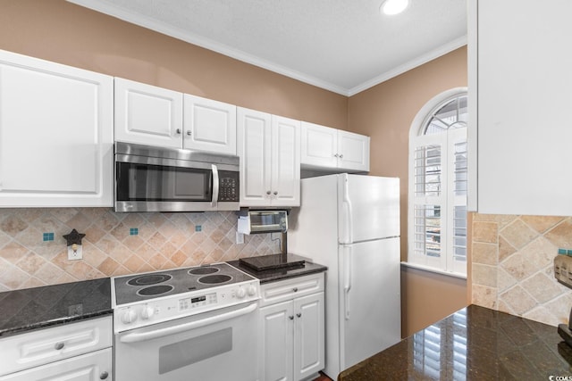 kitchen with white appliances, white cabinetry, tasteful backsplash, and plenty of natural light