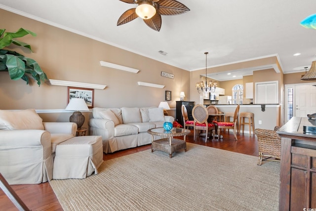 living room featuring ceiling fan with notable chandelier, hardwood / wood-style floors, and ornamental molding