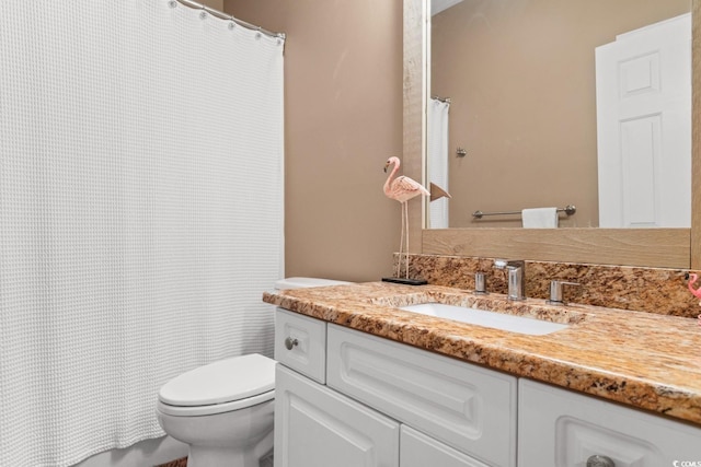 bathroom with toilet and vanity