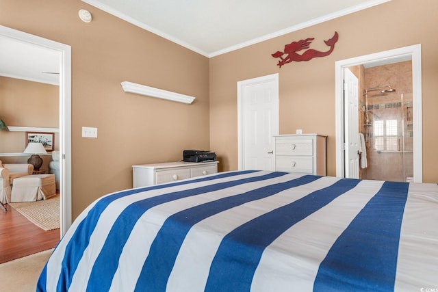 bedroom with ornamental molding, ensuite bathroom, and carpet