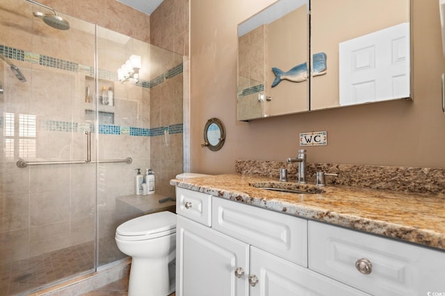 bathroom with a shower with door, tile patterned floors, vanity, and toilet