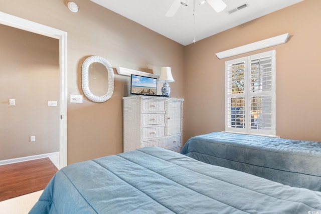 bedroom with ceiling fan and hardwood / wood-style floors