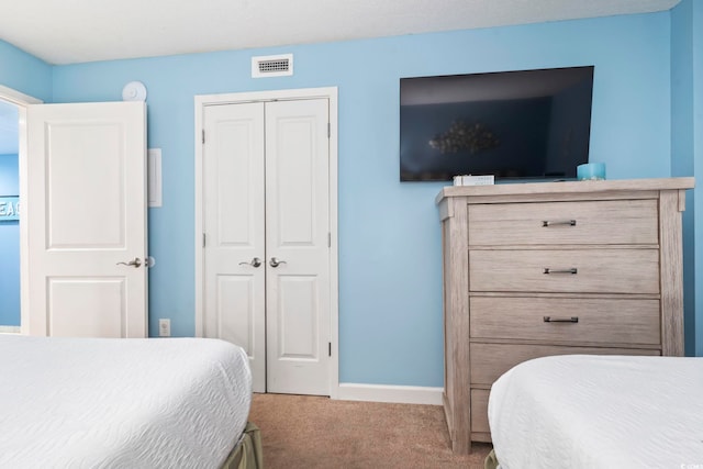 carpeted bedroom featuring a closet