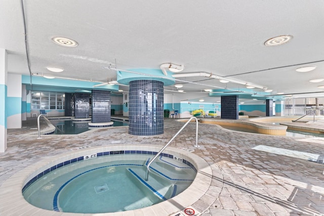 view of swimming pool with an indoor hot tub