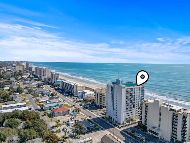 aerial view with a water view and a beach view