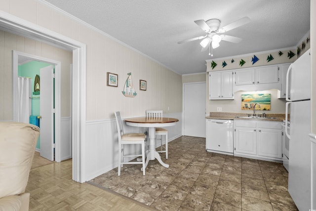 kitchen featuring sink, a textured ceiling, ornamental molding, white appliances, and white cabinets