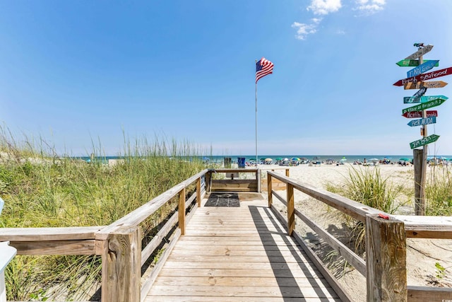 view of property's community with a view of the beach and a water view