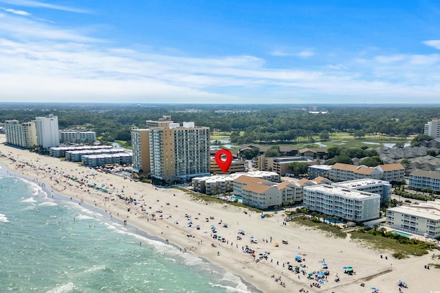 birds eye view of property with a view of the beach and a water view