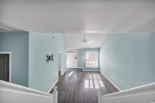 interior space with vaulted ceiling and dark hardwood / wood-style flooring