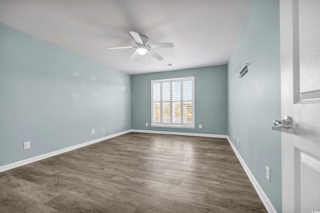 spare room featuring ceiling fan and dark hardwood / wood-style flooring