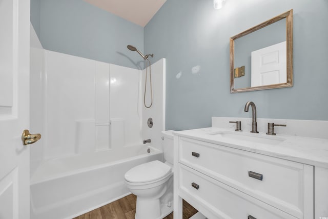 full bathroom with hardwood / wood-style flooring, toilet, vanity, and shower / washtub combination