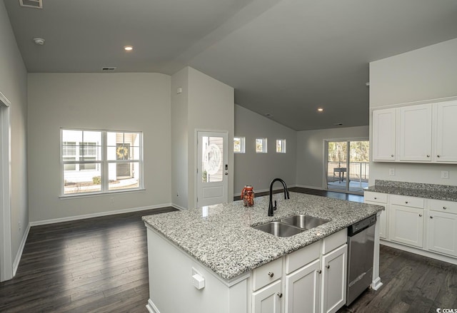 kitchen with dishwasher, white cabinetry, an island with sink, sink, and light stone counters