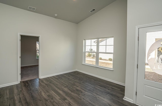 empty room featuring dark hardwood / wood-style flooring and high vaulted ceiling