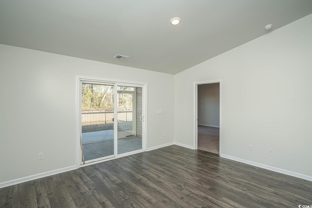 unfurnished room with dark wood-type flooring and lofted ceiling