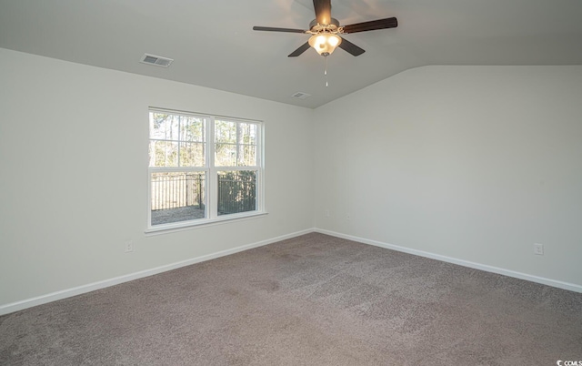 carpeted empty room with ceiling fan and lofted ceiling