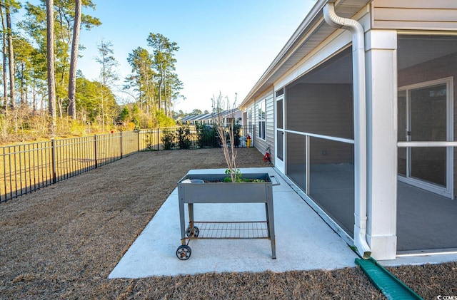 view of patio / terrace featuring a sunroom