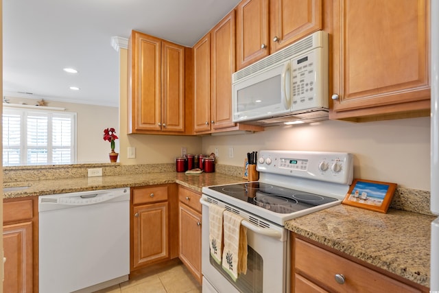 kitchen with white appliances, ornamental molding, light tile patterned floors, and light stone counters