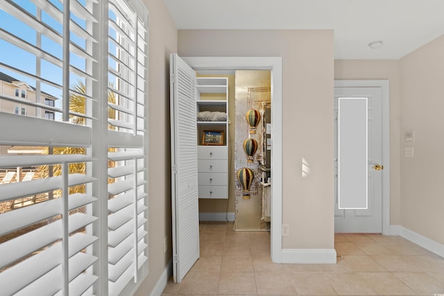 hall with light tile patterned floors