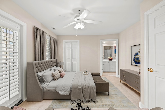 bedroom with connected bathroom, a closet, ceiling fan, and light tile patterned floors