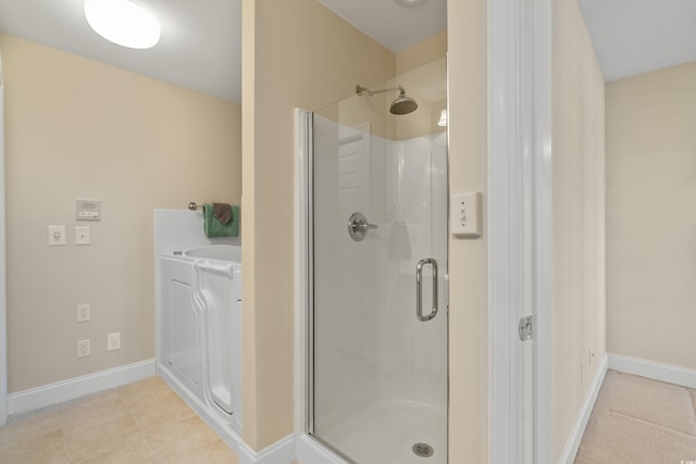 bathroom with a shower with door