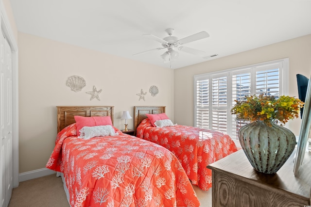 bedroom featuring ceiling fan, a closet, and carpet flooring