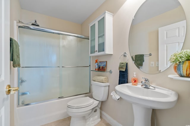 bathroom with toilet, bath / shower combo with glass door, and tile patterned floors