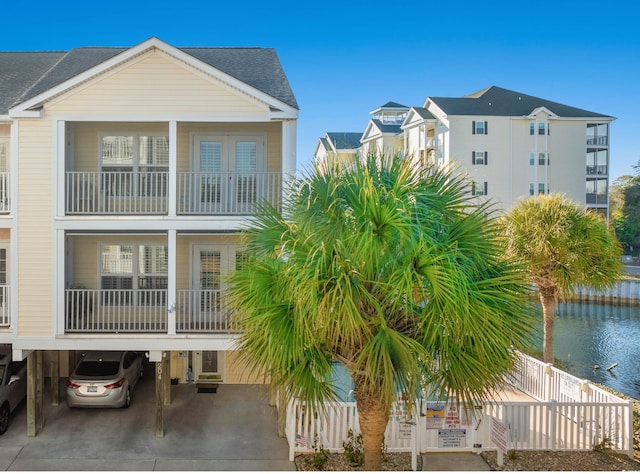 rear view of house featuring a water view and a carport