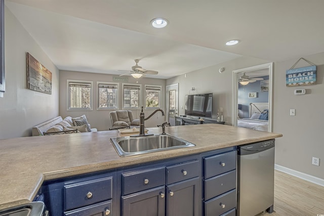 kitchen featuring open floor plan, a ceiling fan, a sink, baseboards, and recessed lighting