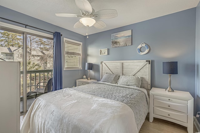 bedroom with multiple windows, wood finished floors, and ceiling fan