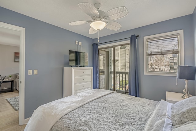 bedroom featuring wood finished floors, access to exterior, and ceiling fan