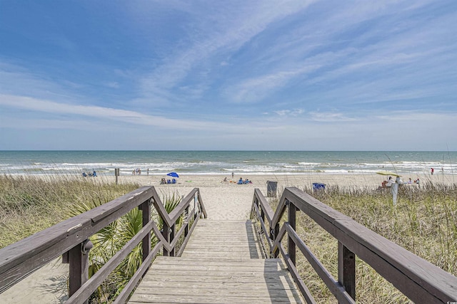 surrounding community with view of water and beach