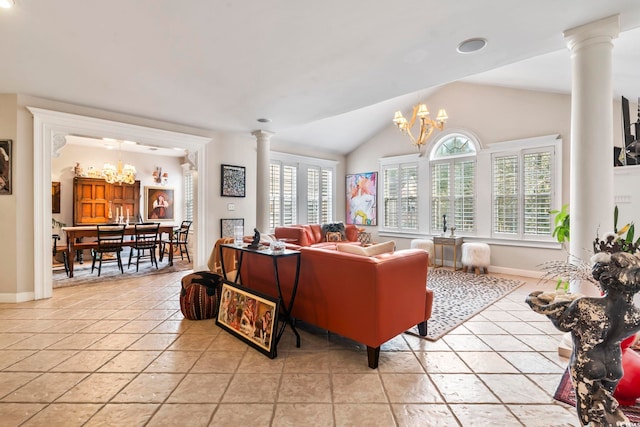 tiled living room with vaulted ceiling, ornate columns, and a chandelier