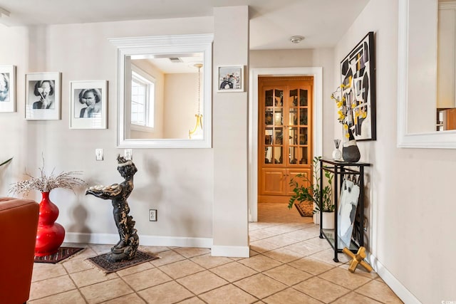 hallway featuring light tile patterned floors