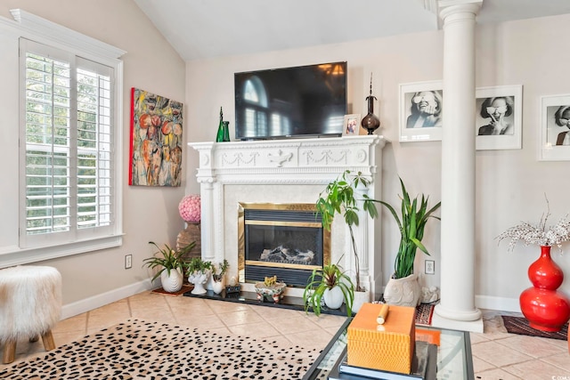 tiled living room with vaulted ceiling and decorative columns