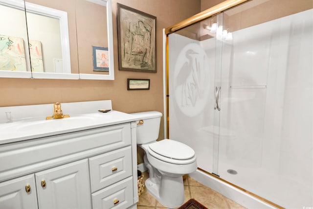 bathroom with tile patterned flooring, toilet, walk in shower, and vanity