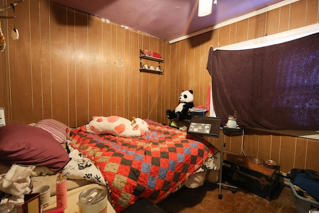 bedroom featuring ceiling fan and wooden walls