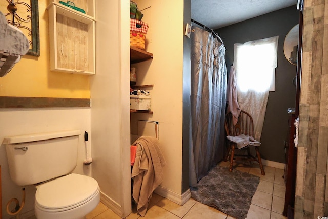 bathroom with walk in shower, tile patterned floors, and toilet