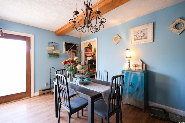 dining space with baseboard heating, a chandelier, wood-type flooring, beamed ceiling, and a textured ceiling