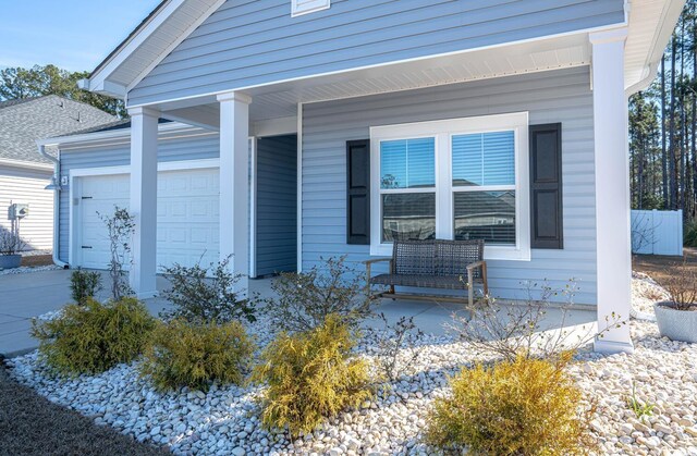 property entrance featuring a garage and covered porch