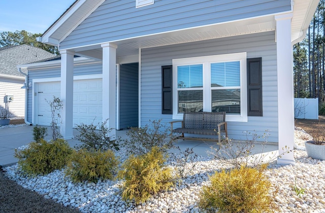 entrance to property with a garage and covered porch