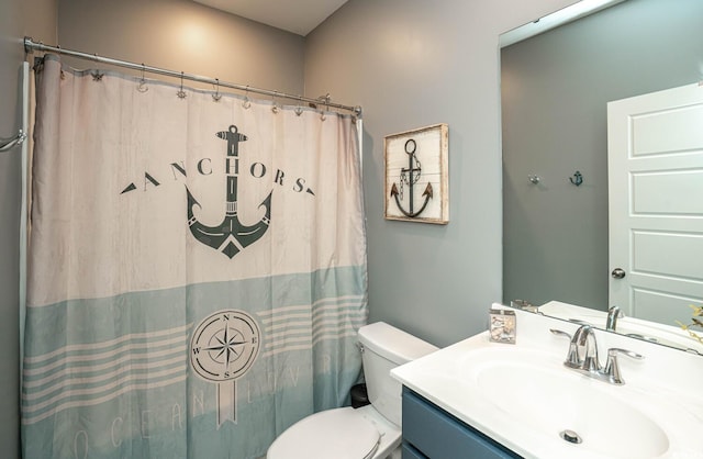 bathroom with vanity, a shower with shower curtain, and toilet