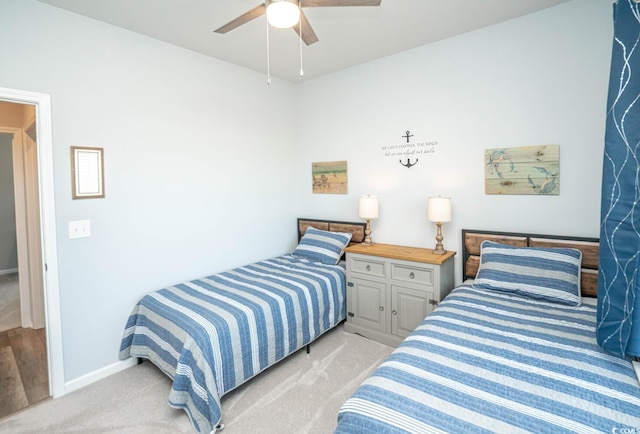 bedroom featuring light carpet and ceiling fan