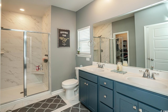 bathroom featuring vanity, toilet, and a shower with shower door