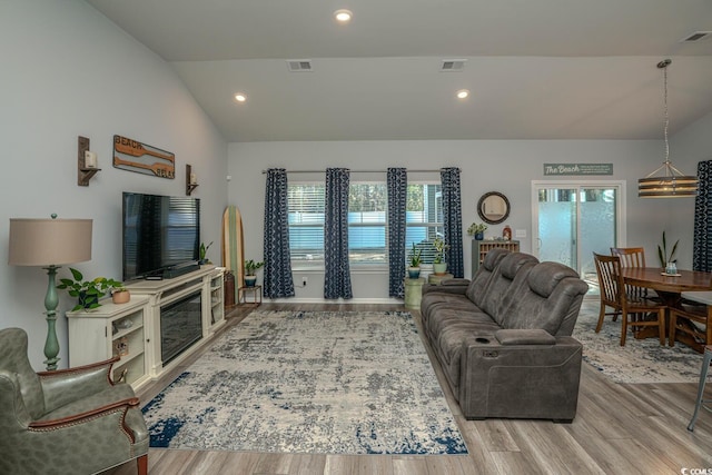 living room featuring vaulted ceiling and light wood-type flooring