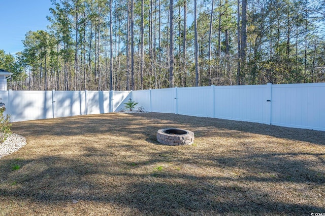 view of yard with an outdoor fire pit